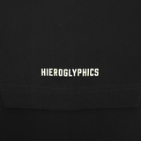 Detailed close-up of white HIEROGLYPHICS wordmark on the sleeve of a black baseball jersey.