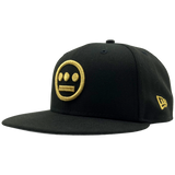 Black New Era cap with gold embroidered Hieroglyphics hip-hop logo on the crown.