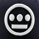 Detailed close-up image of Navy New Era cap with white embroidered Hieroglyphics hip-hop logo on the crown.