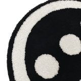 Detailed close up image of round area rug with Hiero logo in black and white.