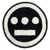 Round area rug with Hiero logo in black and white.