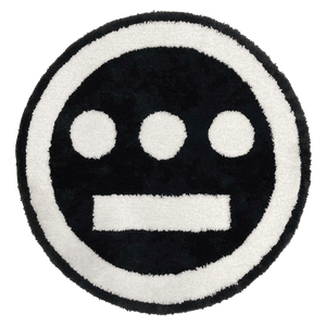 Round area rug with Hiero logo in black and white.