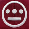Detailed close up of embroidered white Hiero logo on cardinal red Mitchell & Ness snapback hat.