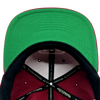 Detailed close up of cardinal red Hiero x Mitchell & Ness hat with green under visor and Mitchell & Ness taping inside crown.